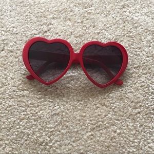 Heart shaped, red sunglasses.